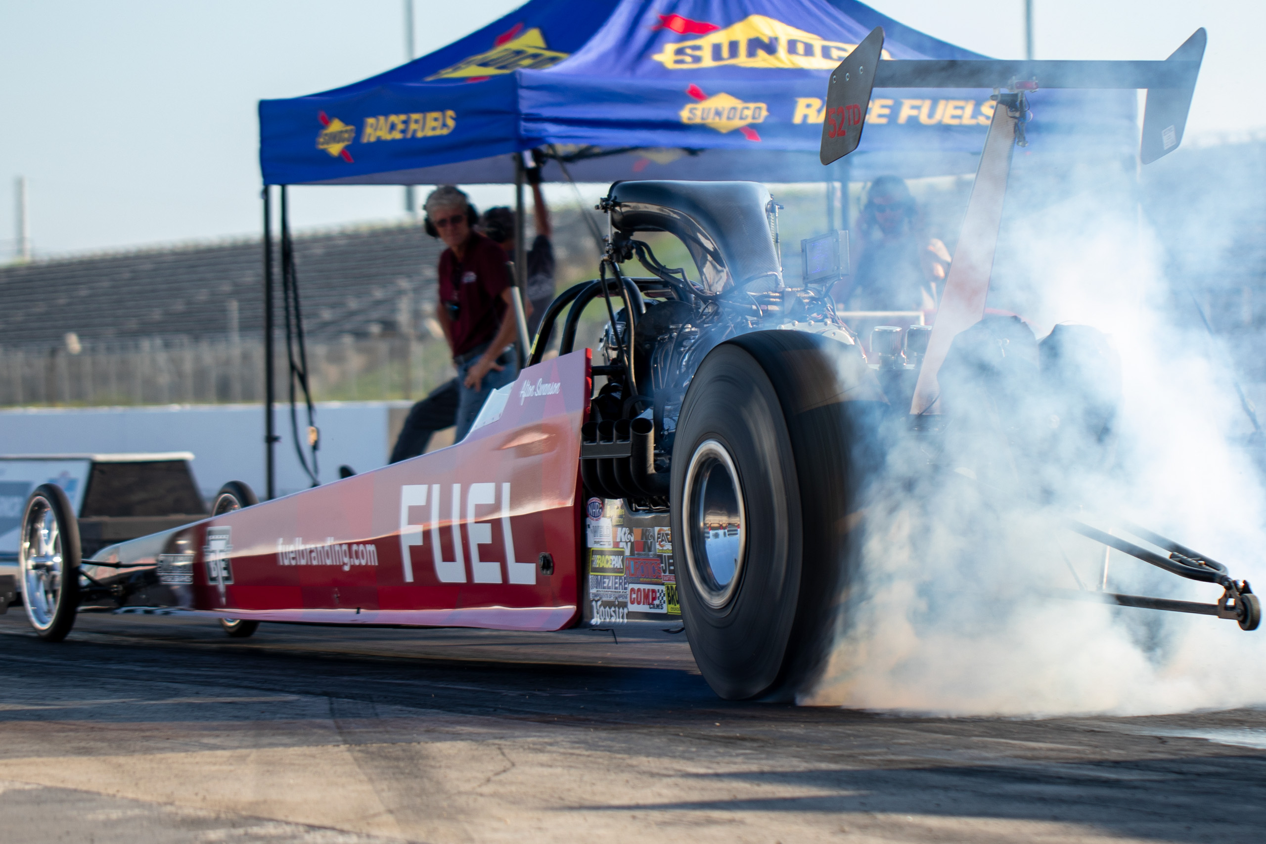 FUEL branded dragster burning out on track