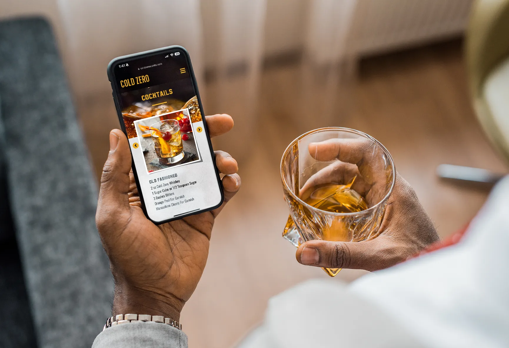 Man holding phone looking at Cold Zero cocktail recipe