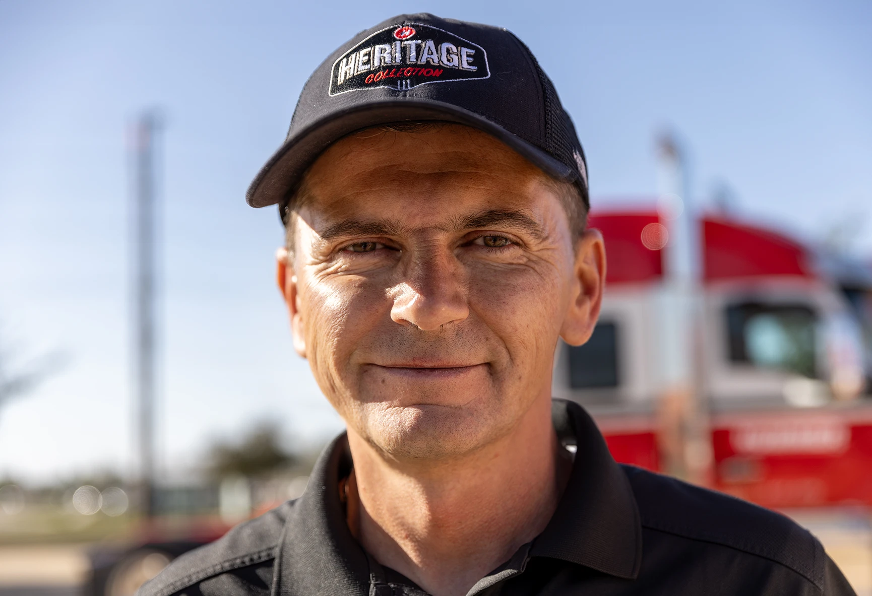 Employee smiling wearing Heritage Collection hat