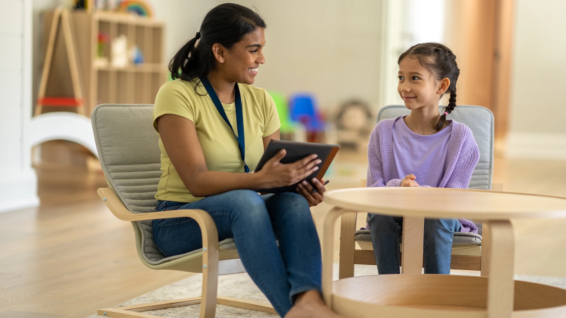 Therapist and child at table