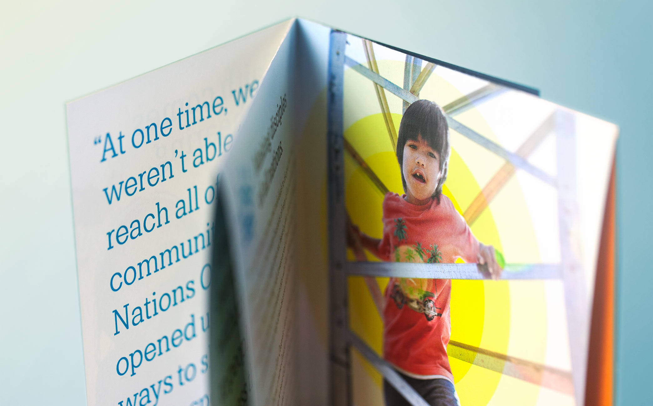 Nations One brochure interior spread with kid on radio tower